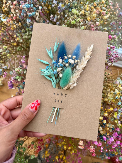 Handmade 'Baby Boy' card with dried flowers arranged in a removable slot. The flowers can be taken out and placed in a small vase, creating a lasting keepsake to celebrate the arrival of a baby boy.